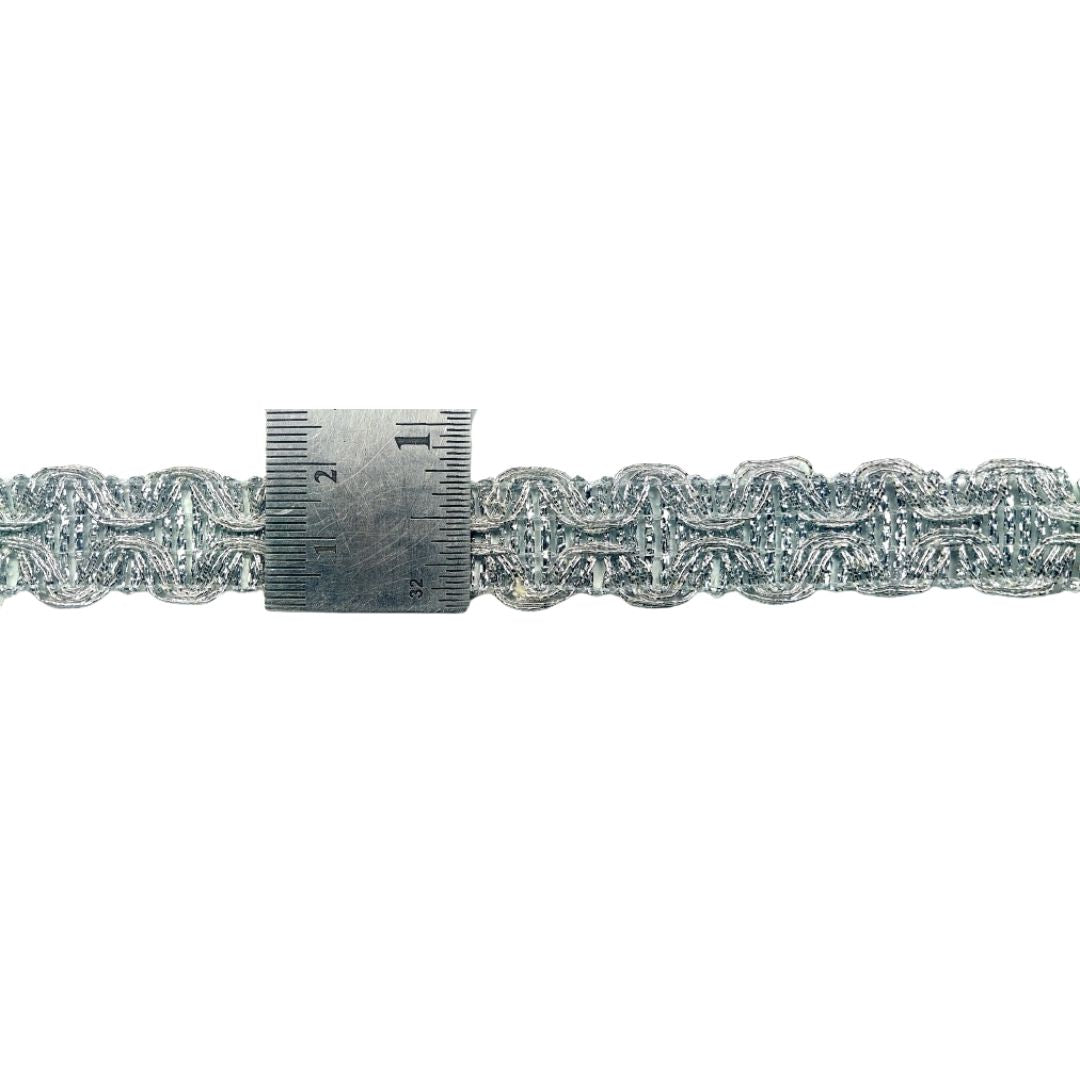 Silver chain with a ruler for scale on a white background